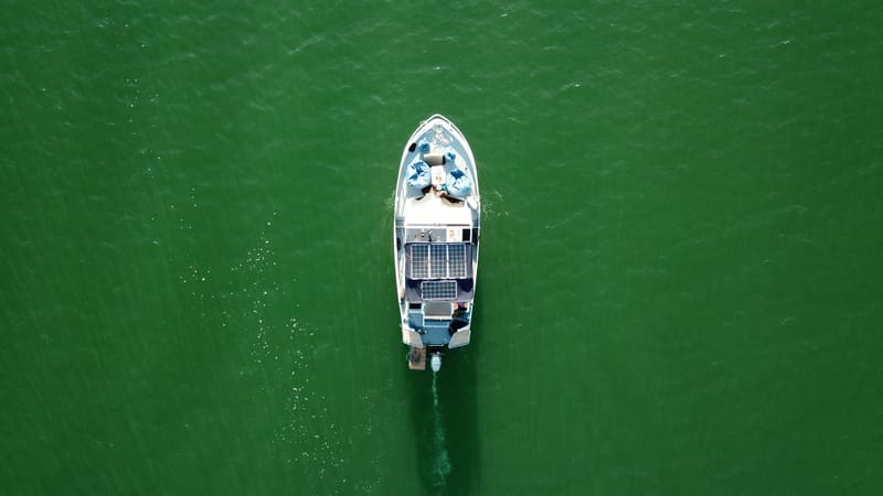 Aerial top-down view of the boat with solar panels